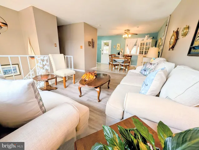 a kitchen with granite countertop white cabinets and black appliances