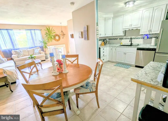 a living room with blue lights with furniture and floor to ceiling windows