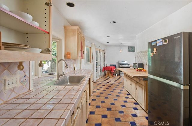 a kitchen with a sink stove and refrigerator