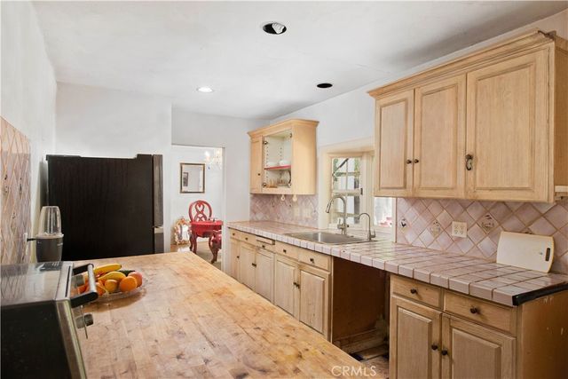 a spacious bedroom with a bed and wooden floor