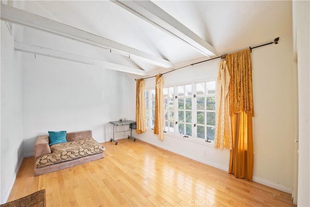 a view of a room with wooden floor and windows
