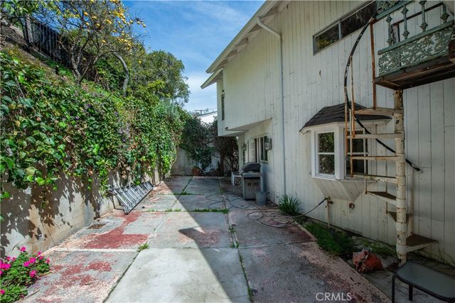a view of patio with table and chairs and potted plants