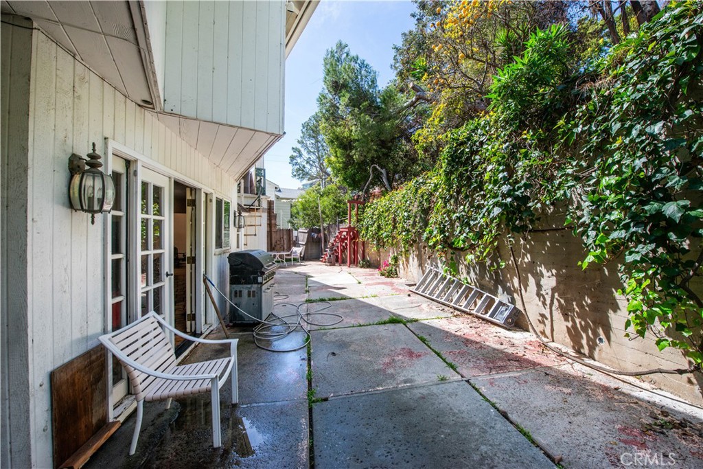 507 West Rustic Road Santa Monica, CA 90402 - Photo 18 of 19 a view of patio with table and chairs and potted plants