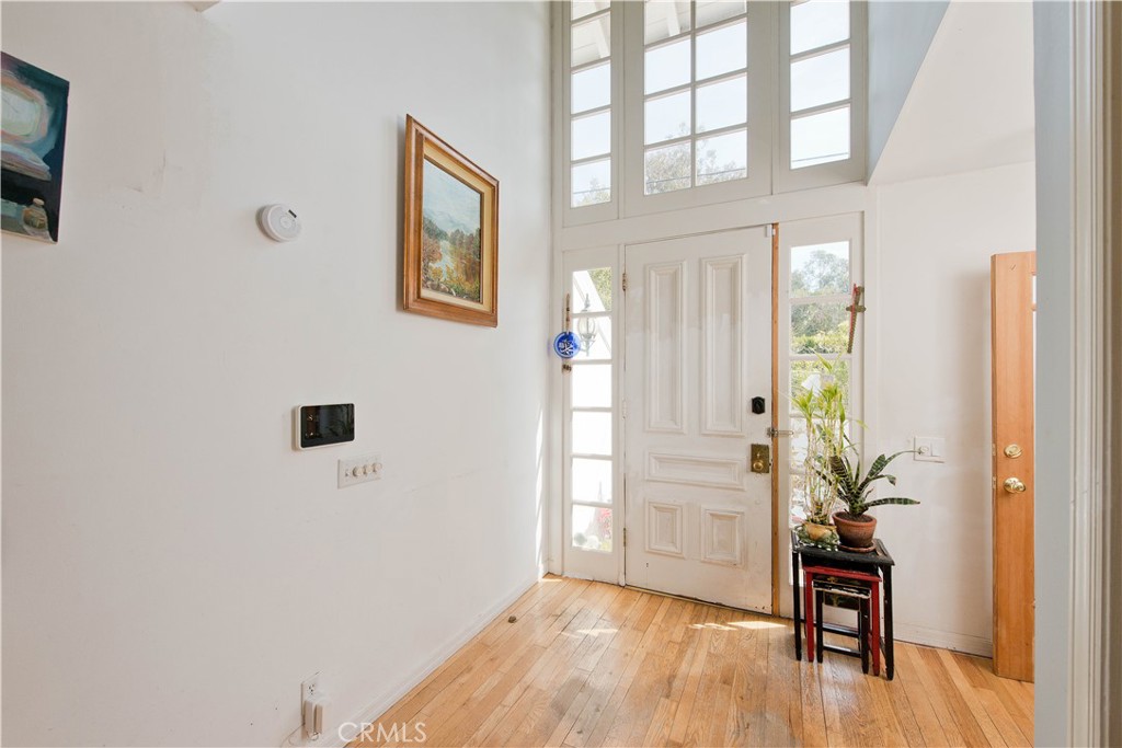 507 West Rustic Road Santa Monica, CA 90402 - Photo 2 of 19 a view of a hallway with wooden floor and a living room