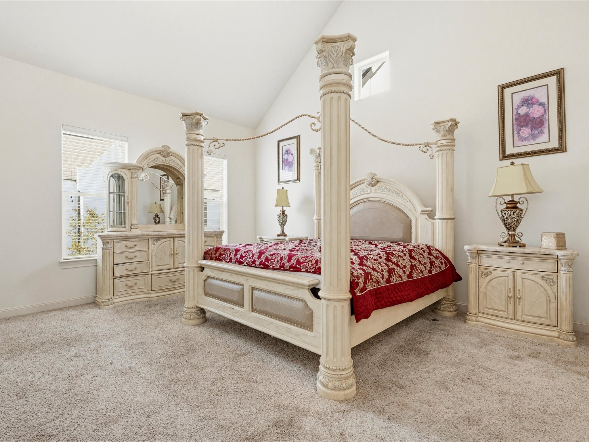 9427 London Bridge Station Houston, TX 77045 - Photo 21 of 30 This elegant bedroom features a luxurious four-poster bed with ornate detailing, complemented by matching vintage-style furniture. The room is bright and spacious, with high ceilings, soft carpeting, and tasteful decor, creating a warm and inviting atmosphere.