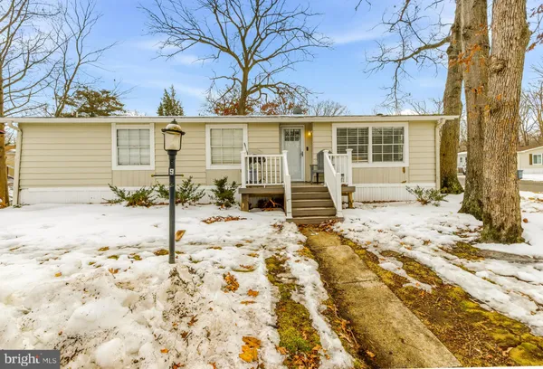 a view of a house with a yard covered in snow