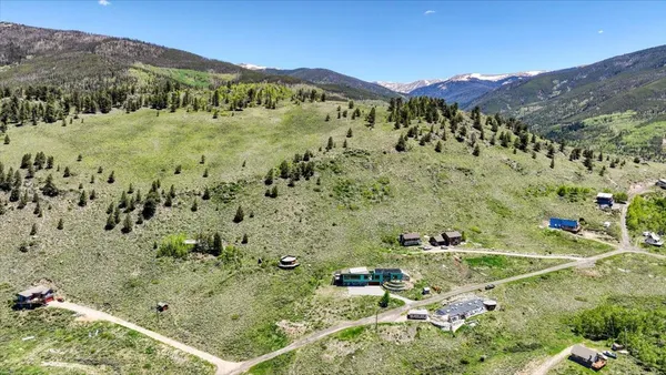a view of a lush green hillside and houses