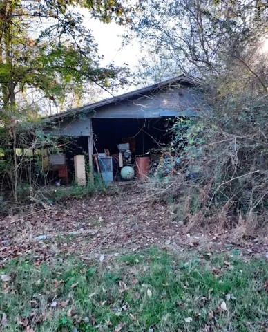 a view of a barn with a tree
