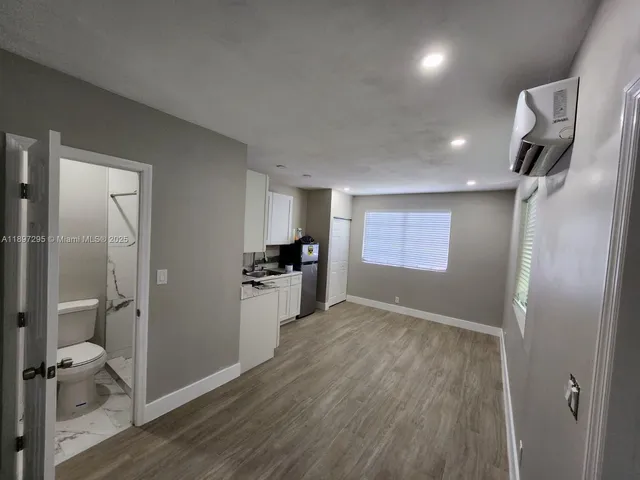 a view of hallway with wooden floor