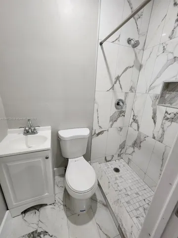 a white toilet sitting next to a bathroom sink