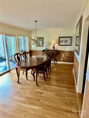 a view of a dining room with furniture and a chandelier
