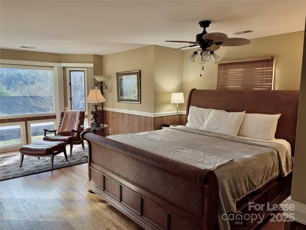 a bedroom with a bed and a chandelier