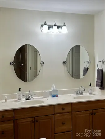 a bathroom with a double vanity sink and a mirror