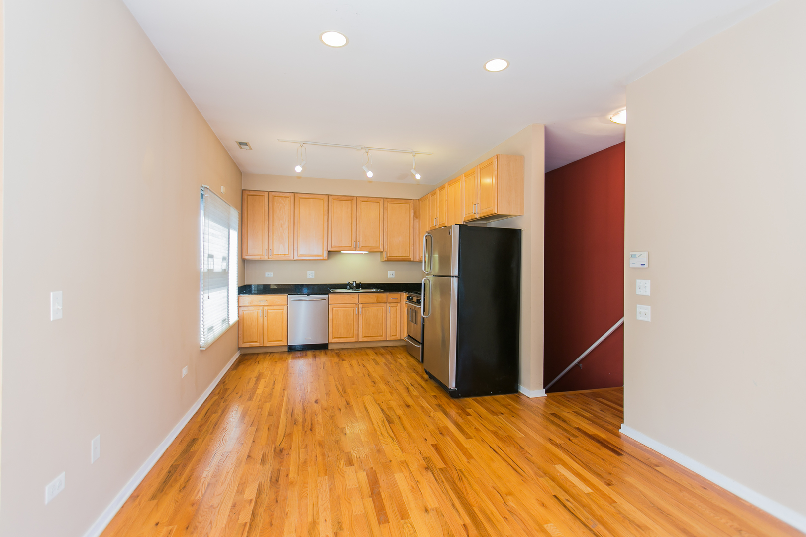1808 South Michigan Avenue, Unit 38 Chicago, IL 60616 - Photo 6 of 18 a view of kitchen with stainless steel appliances refrigerator and wooden floor