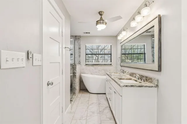 a bathroom with a tub sink and a window