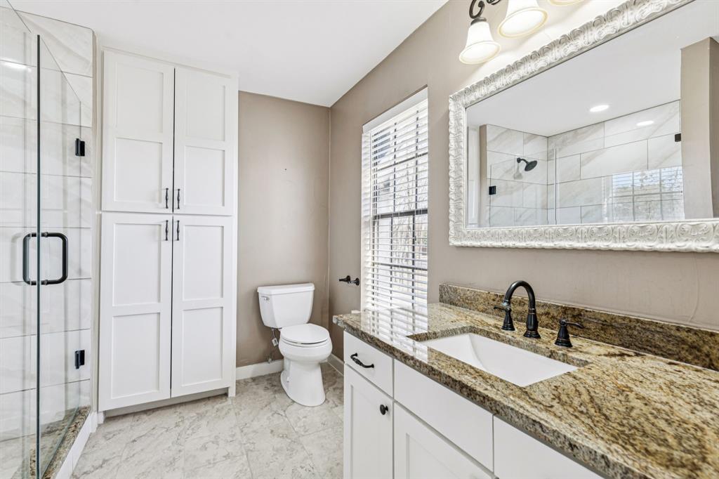 209 McMillen Road Lucas, TX 75002 - Photo 23 of 38 a bathroom with a granite countertop sink mirror vanity and toilet