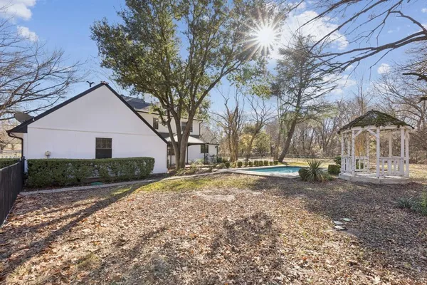 a view of yard with trees in the background