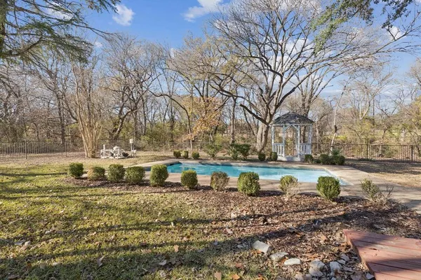 a view of a yard with swimming pool