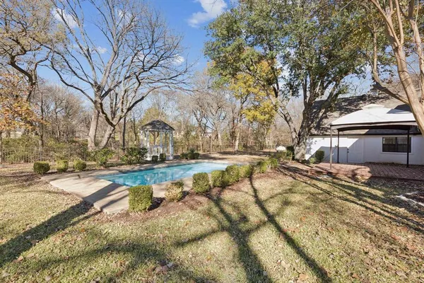 a view of a white house with a yard covered with snow in front of house