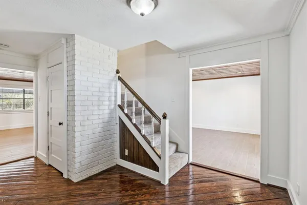 a view of an entryway with wooden floor