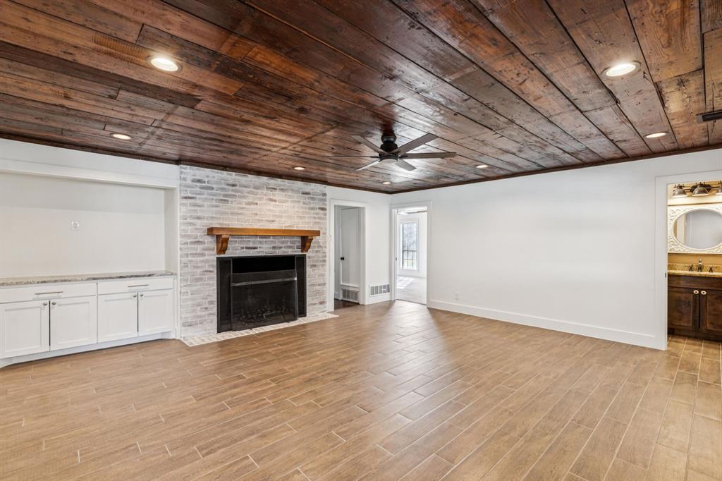 209 McMillen Road Lucas, TX 75002 - Photo 6 of 38 a view of an empty room with a fireplace and a window