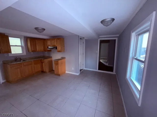a view of a kitchen with furniture and a sink