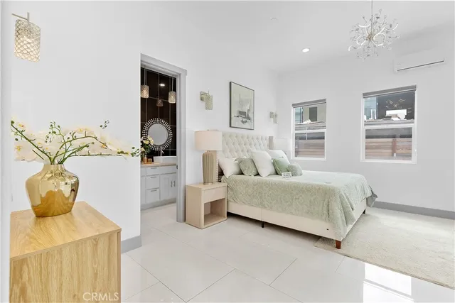 a bedroom with a bed and potted plant