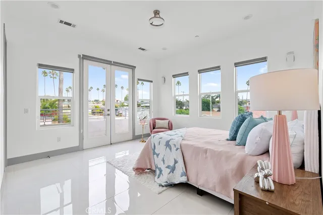 a bedroom with a bed and large window