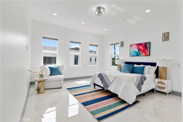 a spacious bedroom with a bed and glass windows