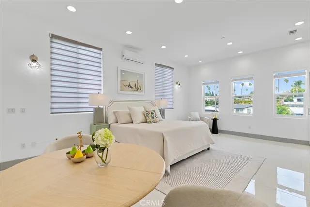 a spacious bedroom with a bed and window