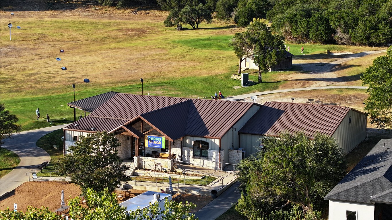 217 Lakefront Drive Point Venture, TX 78645 - Photo 11 of 13 a view of a house with lawn chairs and a table