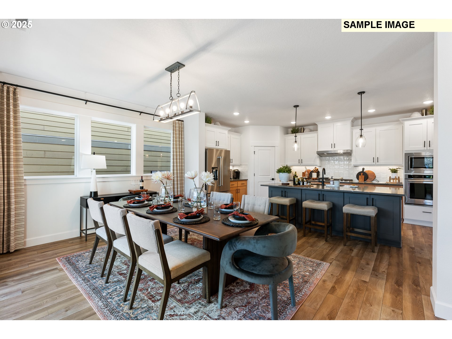 16502 Southwest Deer Terrace Durham, OR 97224 - Photo 16 of 42 a kitchen with a dining table chairs and refrigerator