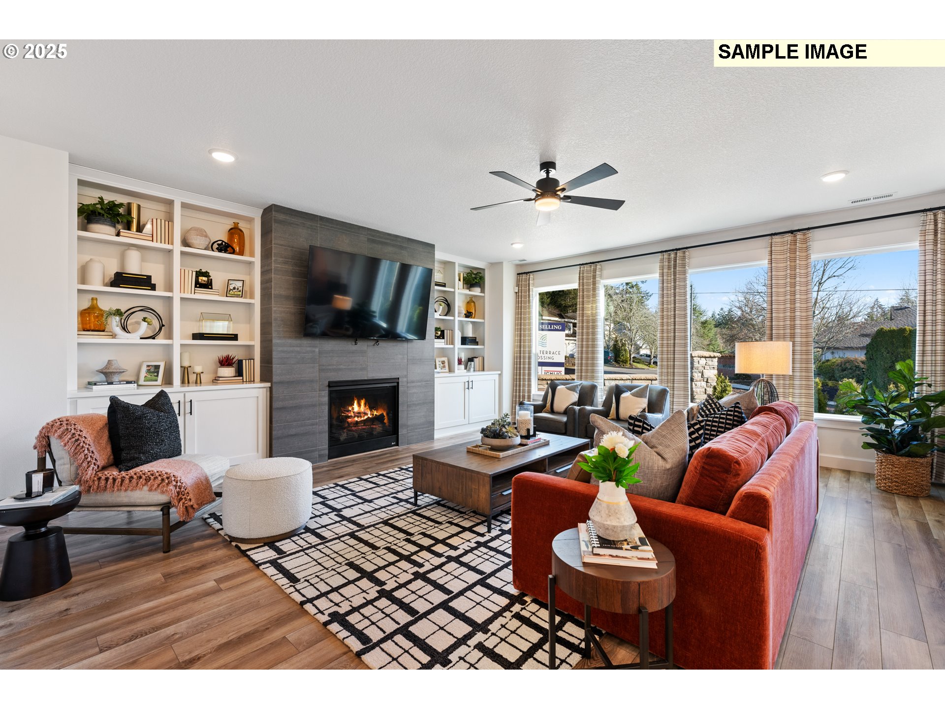 16502 Southwest Deer Terrace Durham, OR 97224 - Photo 19 of 42 a living room with furniture a flat screen tv and a fireplace
