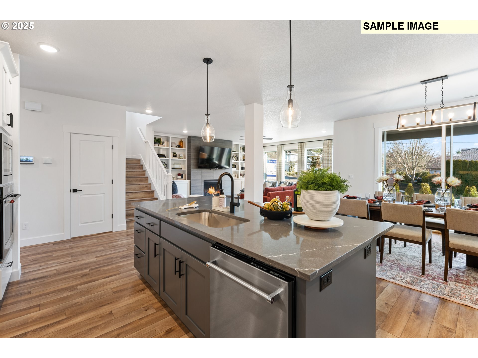 16502 Southwest Deer Terrace Durham, OR 97224 - Photo 10 of 42 a kitchen with kitchen island granite countertop a sink cabinets and wooden floor