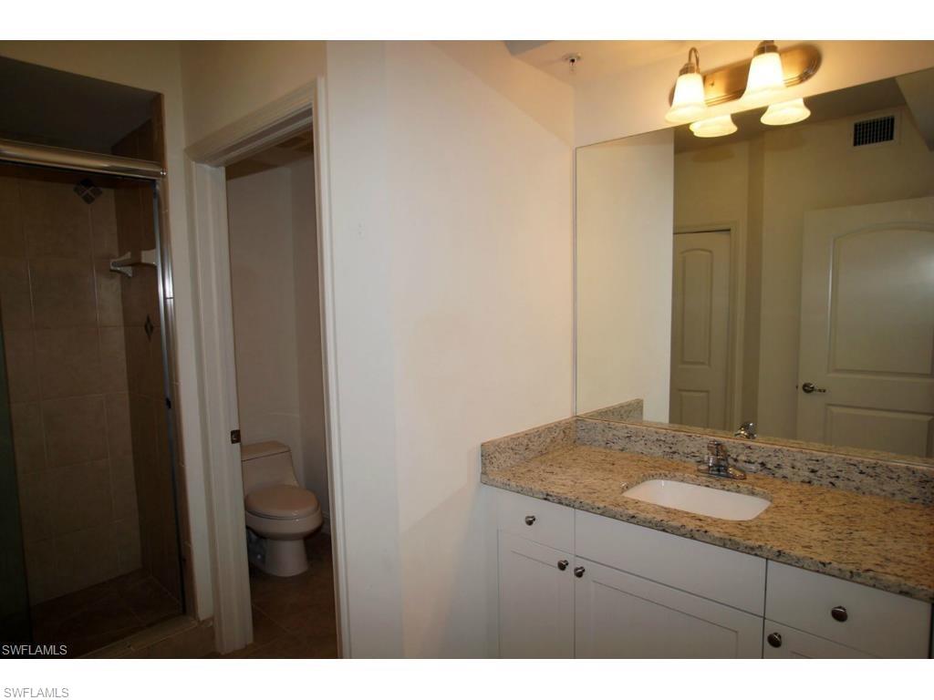 1100 Pine Ridge Road, Unit B102 Naples, FL 34108 - Photo 5 of 9 a bathroom with a granite countertop sink mirror and double