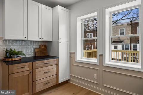 a kitchen with cabinets and window