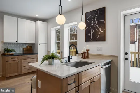 a kitchen with stainless steel appliances a sink a counter space and cabinets