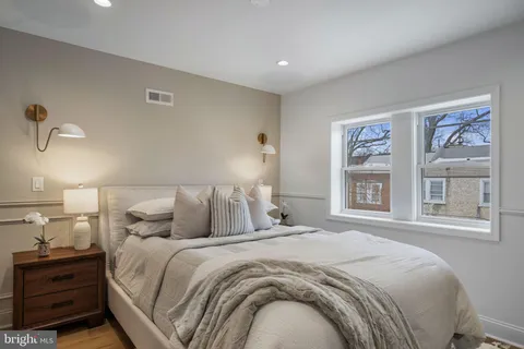 a bedroom with a large bed and a window