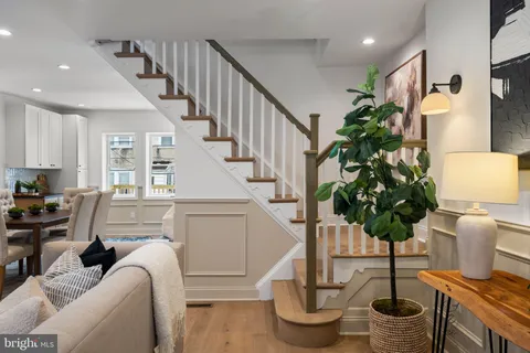 a living room with furniture flowers and a chandelier
