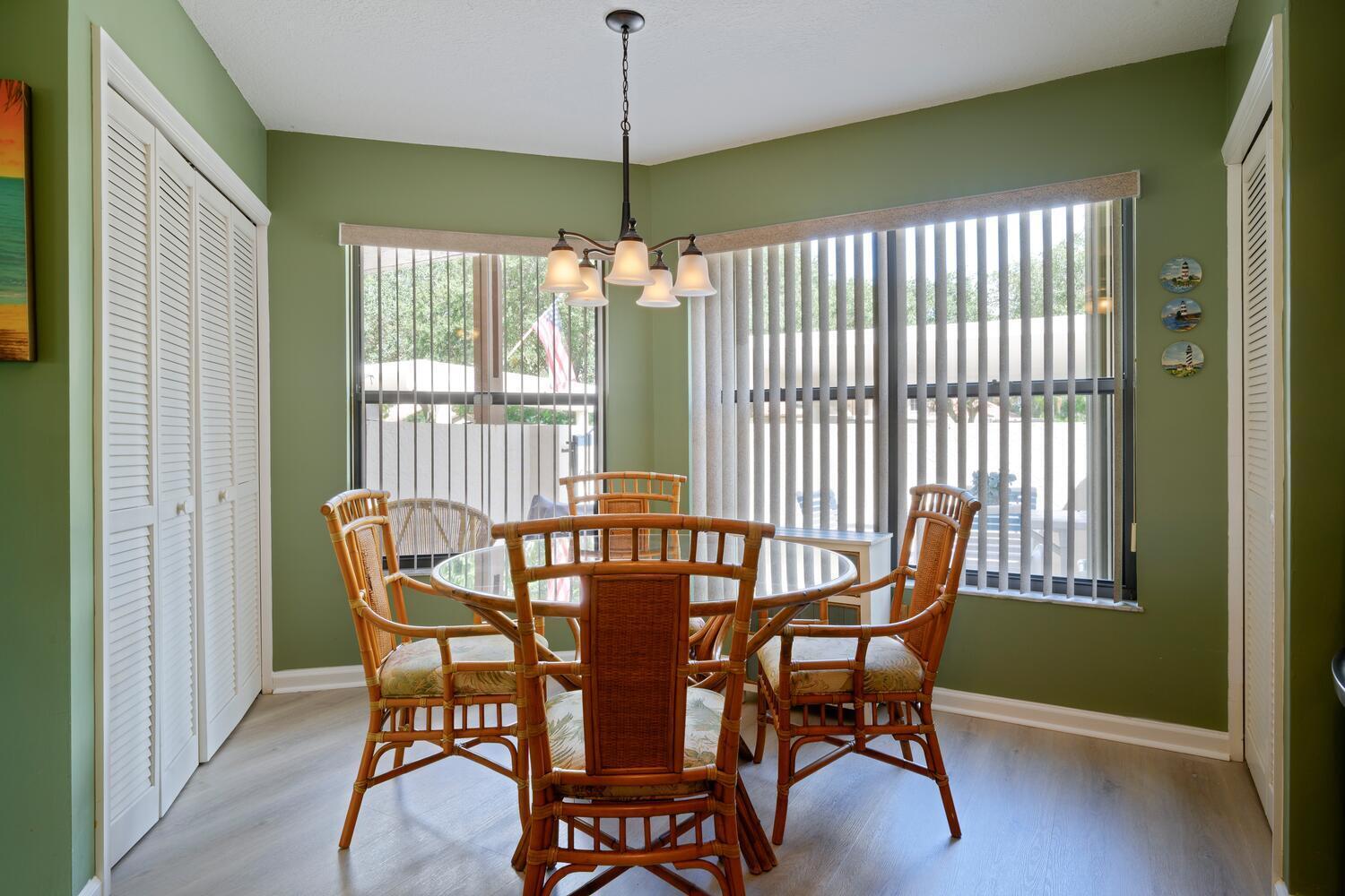 6030 Southeast Martinique Drive, Unit 102 Stuart, FL 34997 - Photo 12 of 31 a view of a dining room with furniture window and outside view