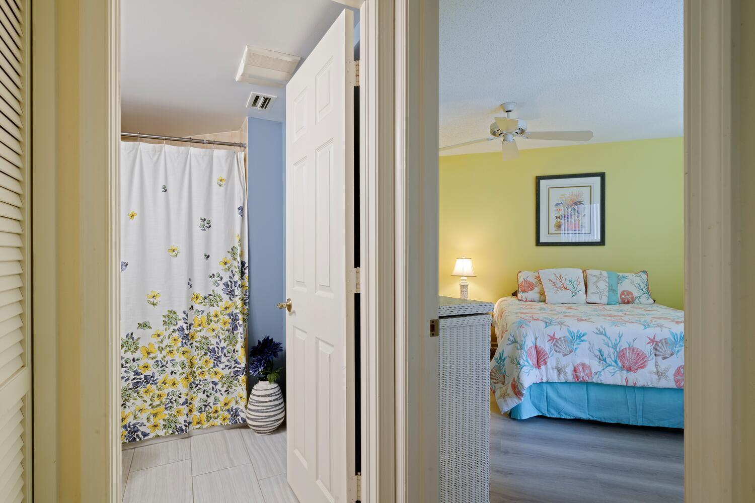 6030 Southeast Martinique Drive, Unit 102 Stuart, FL 34997 - Photo 17 of 31 a bedroom with a bed and a painting on the wall