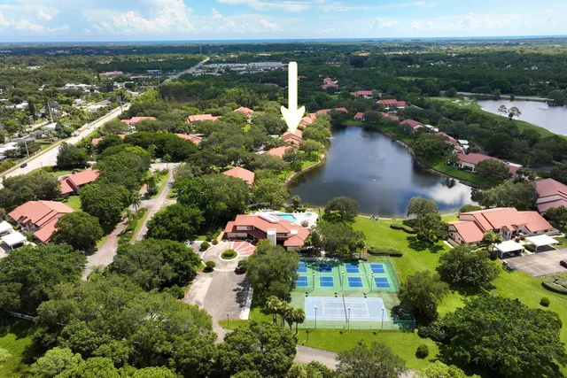 an aerial view of residential houses with outdoor space and lake view