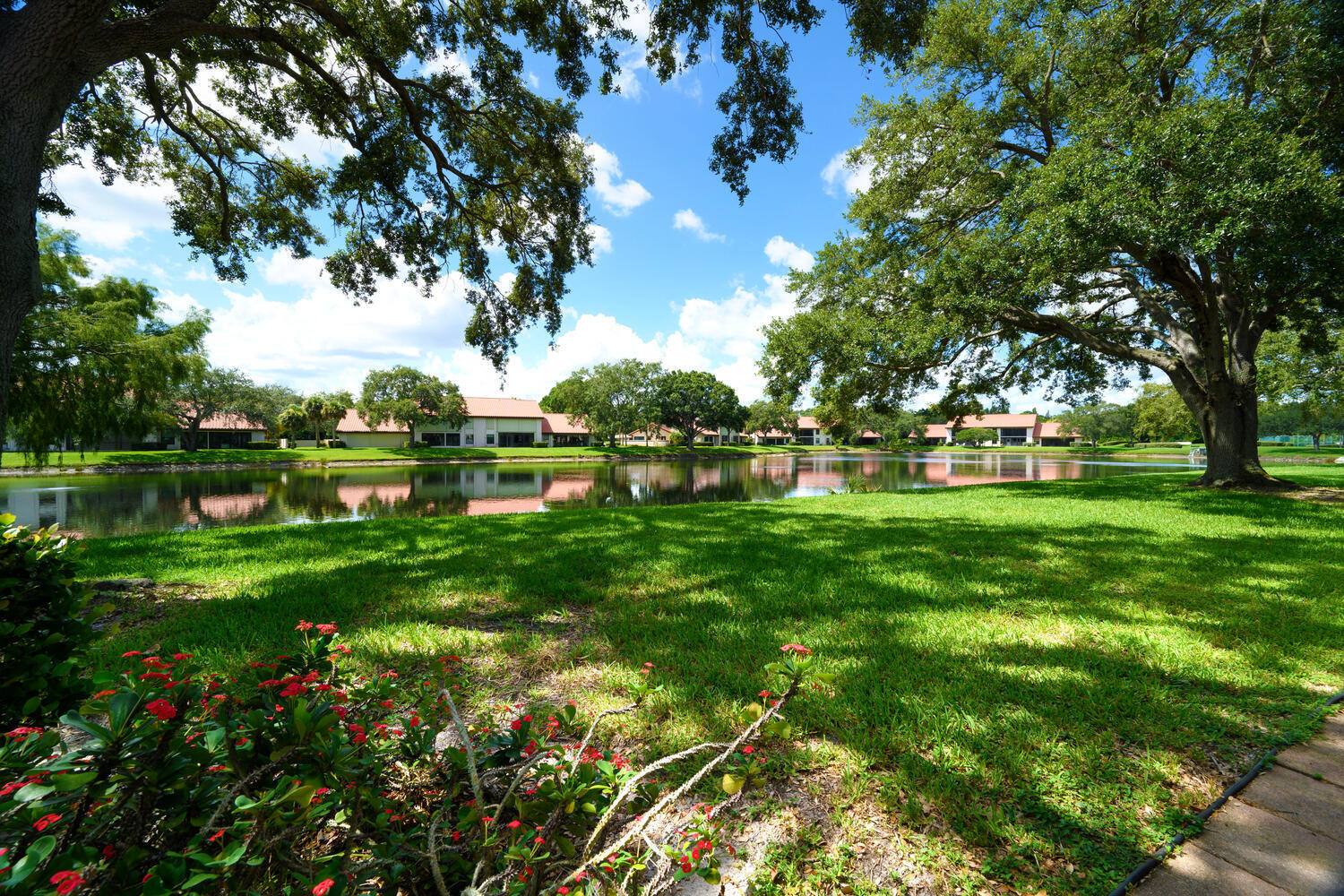 6030 Southeast Martinique Drive, Unit 102 Stuart, FL 34997 - Photo 24 of 31 a view of a park with large trees