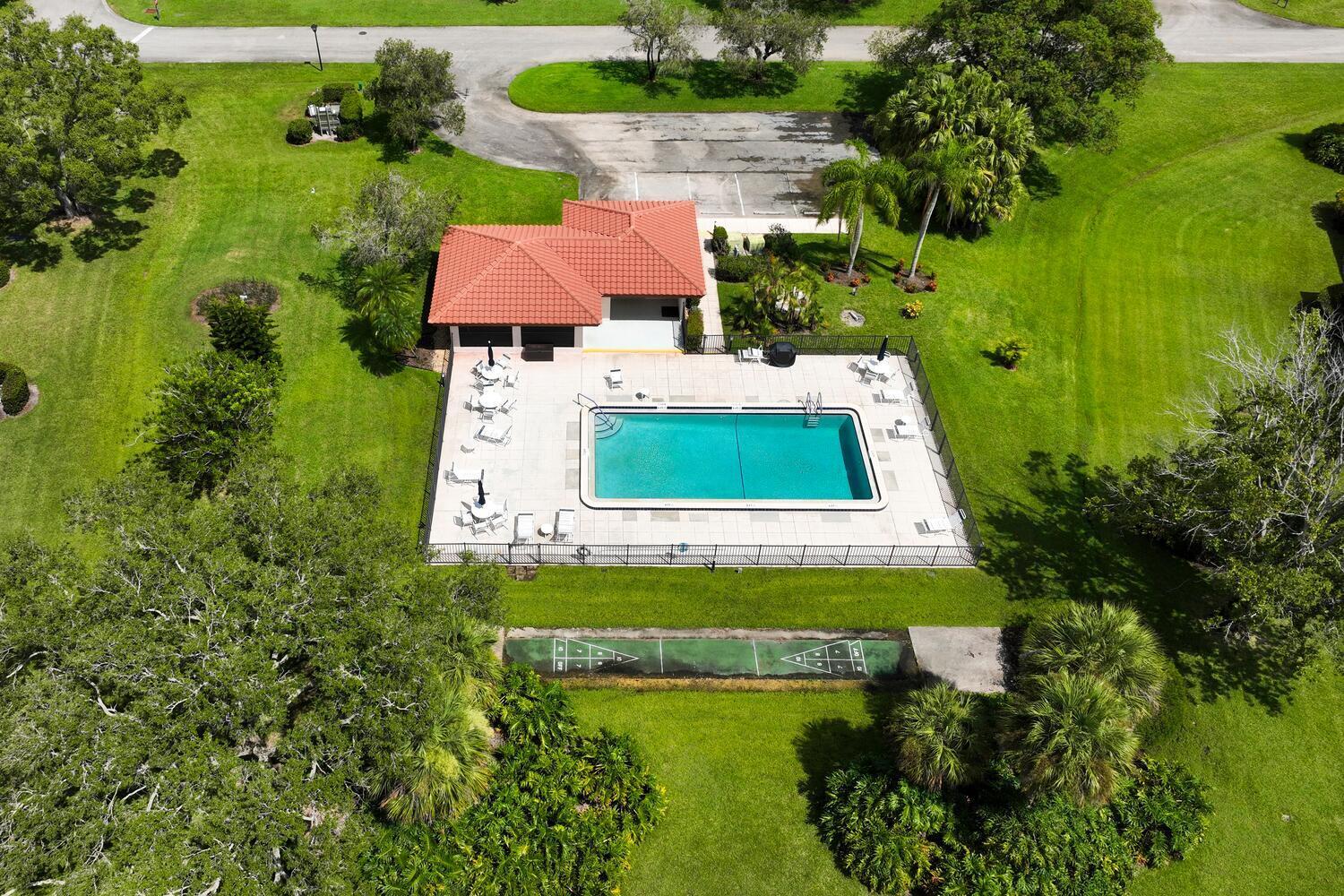 6030 Southeast Martinique Drive, Unit 102 Stuart, FL 34997 - Photo 29 of 31 an aerial view of a house with pool yard swimming pool and outdoor seating