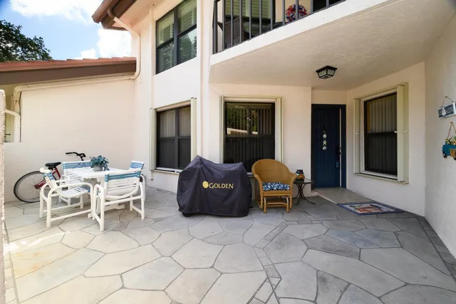 a view of a patio with table and chairs