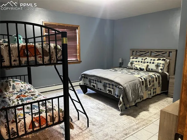 a bedroom with a bed with wooden floor