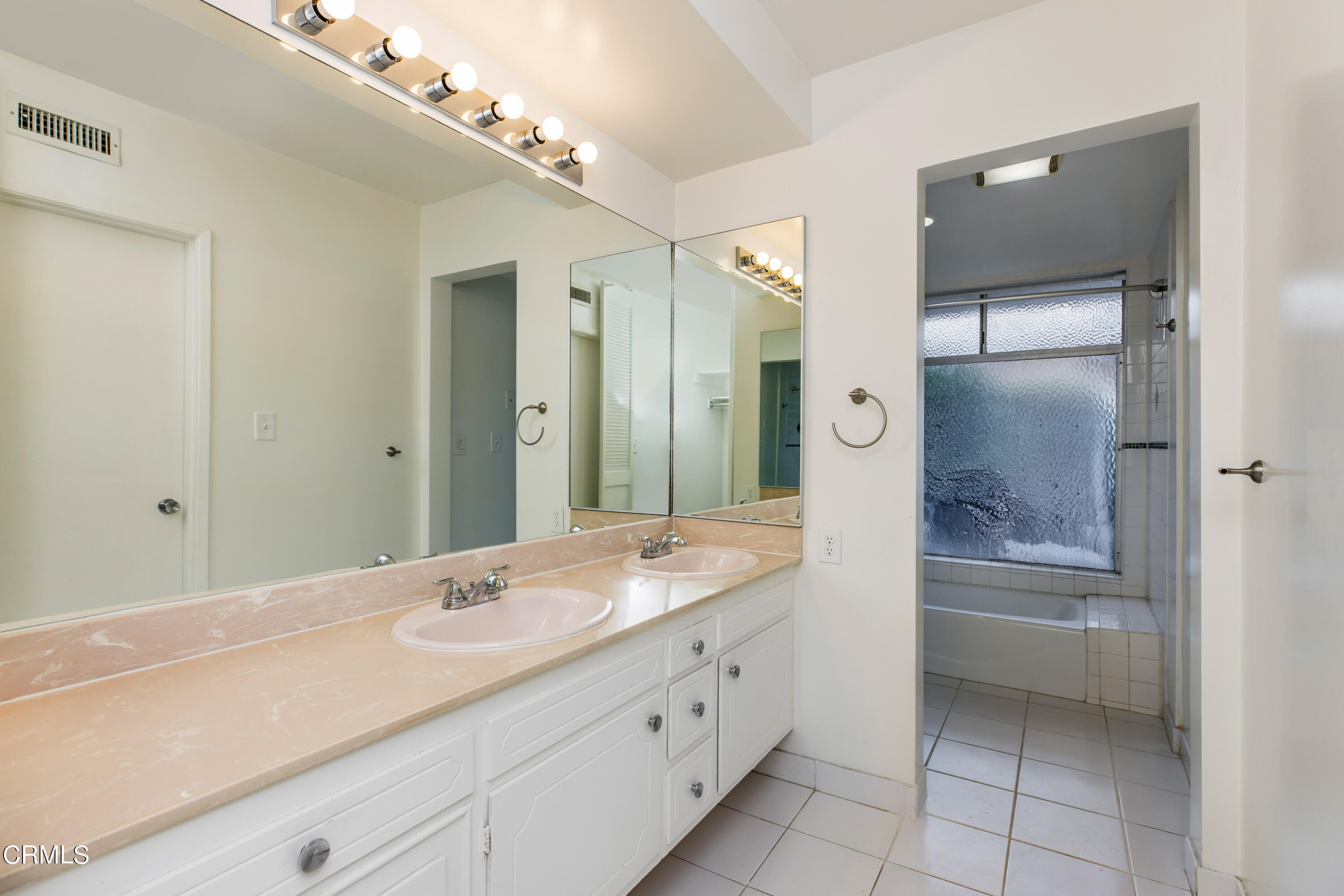 911 Arden Road Pasadena, CA 91106 - Photo 14 of 19 a bathroom with a granite countertop sink a large mirror and a bathtub