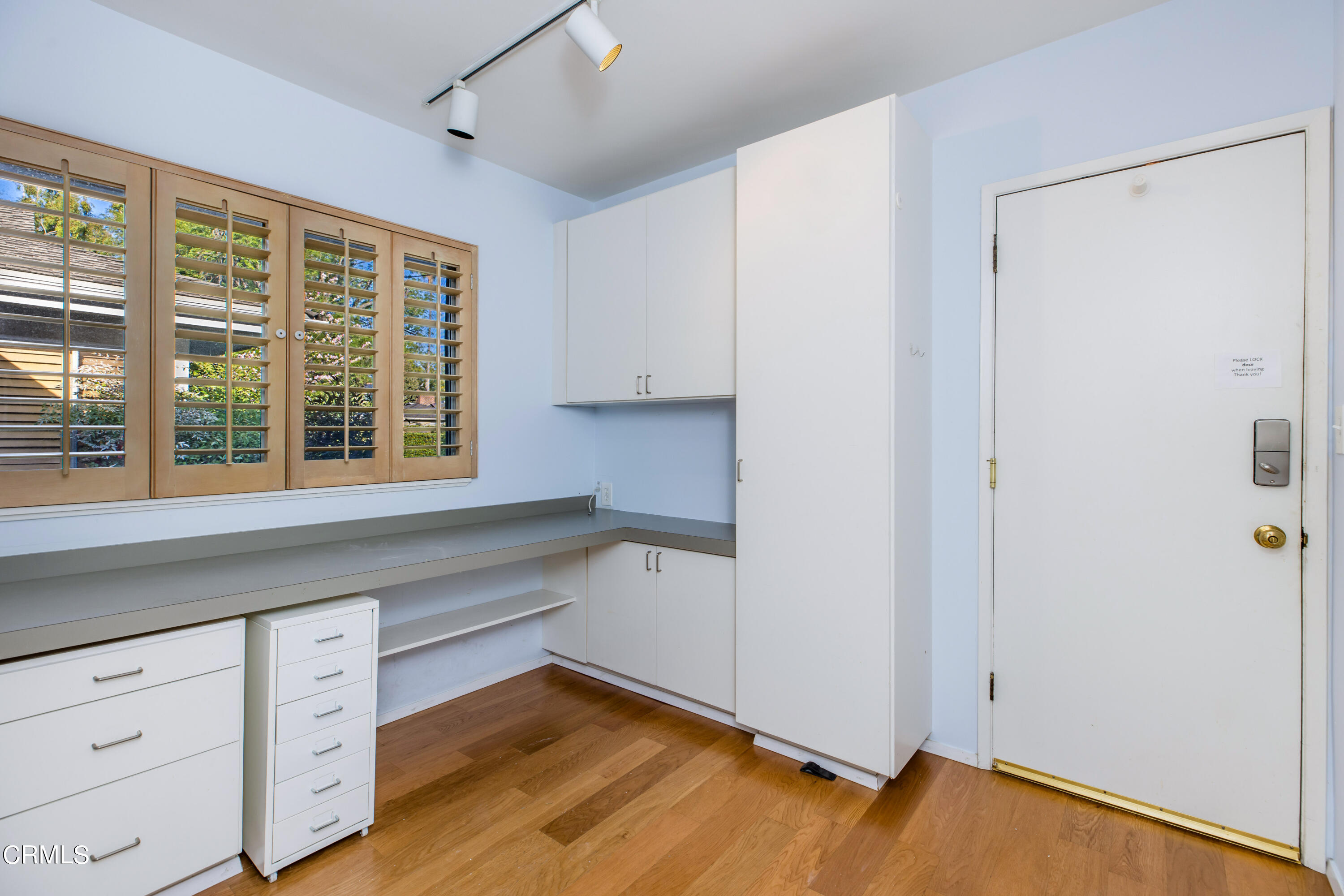 911 Arden Road Pasadena, CA 91106 - Photo 17 of 19 a kitchen with white cabinets and wooden floors