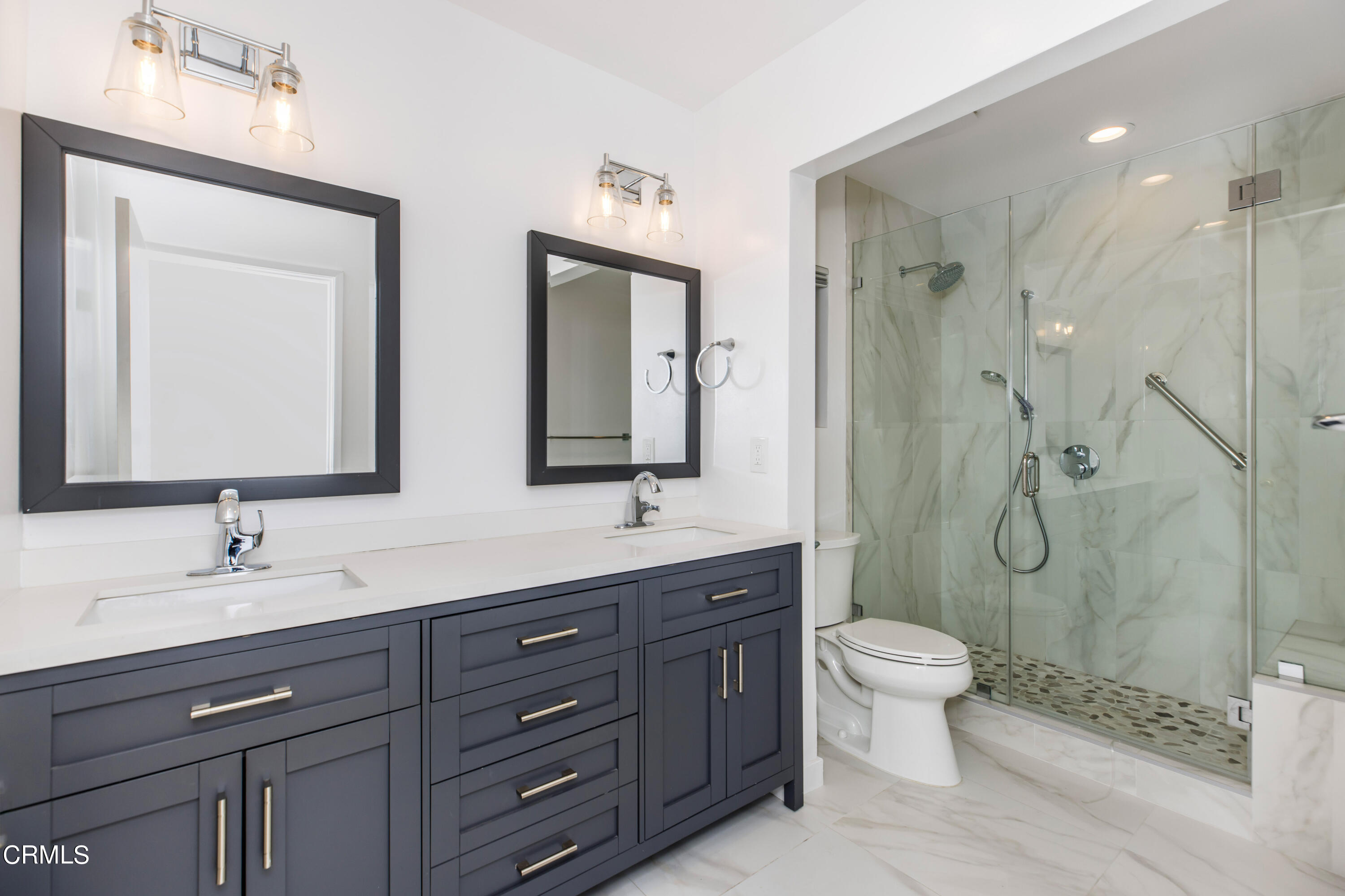 911 Arden Road Pasadena, CA 91106 - Photo 4 of 19 a bathroom with a double vanity sink toilet mirror and shower