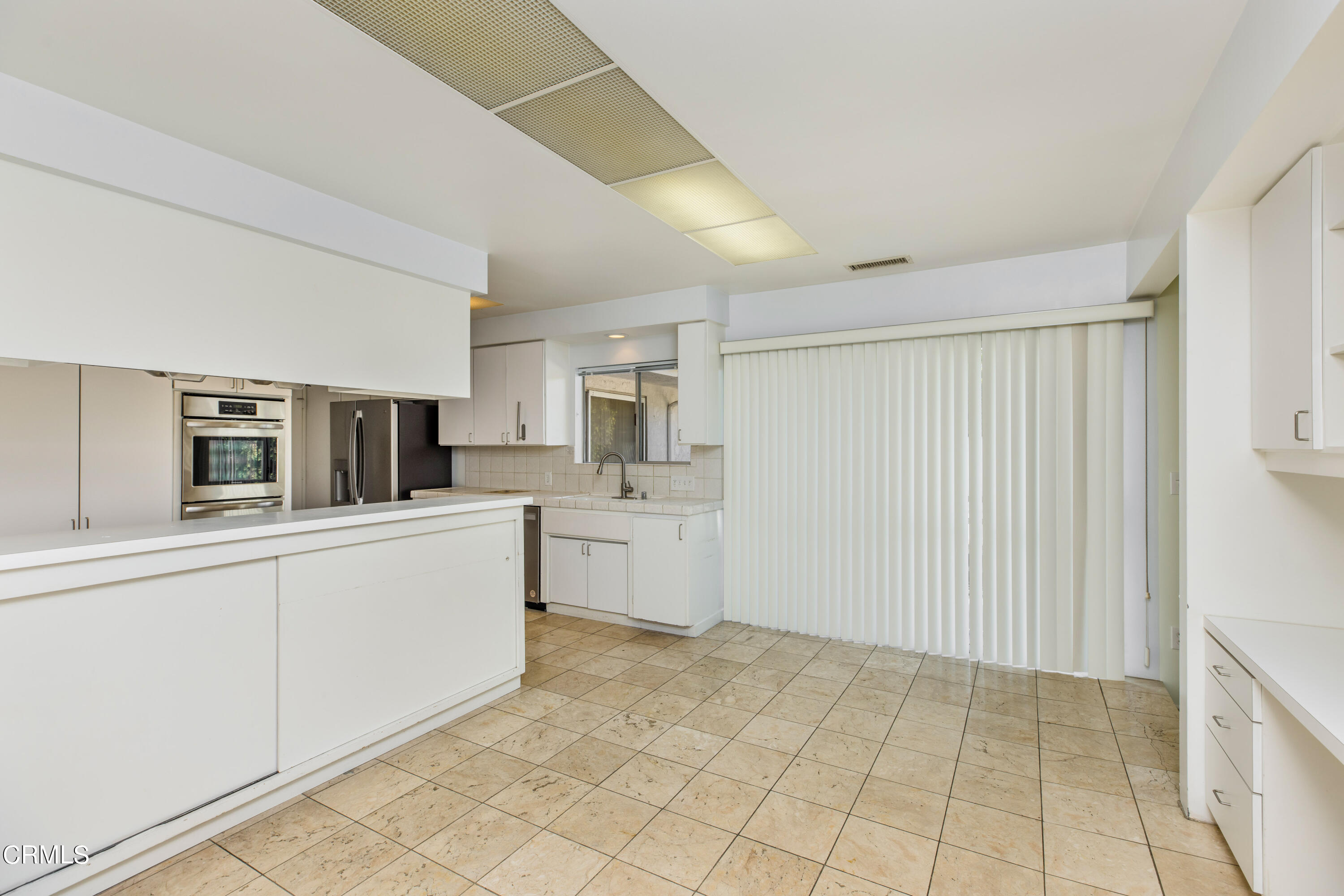 911 Arden Road Pasadena, CA 91106 - Photo 8 of 19 a kitchen with stainless steel appliances a sink and cabinets